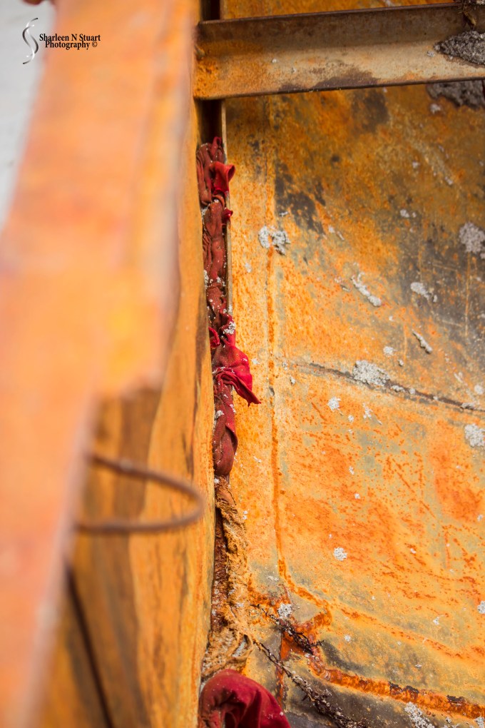 What happens when your boat starts to leak.  It appears that T-shirts were stuffed down into the cracks to try to lessen the seepage.