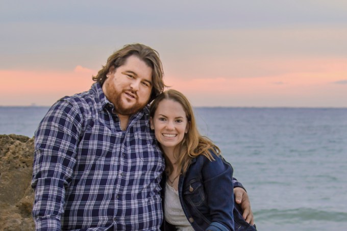 Cameron and Kathryn sitting on the rocks with dog
