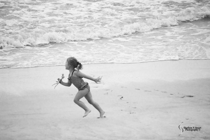 Little girl running on the beach