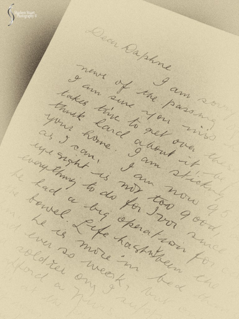 A close-up of a handwritten letter on lined paper addressed to 'Daphne', with cursive writing expressing condolences and personal updates.